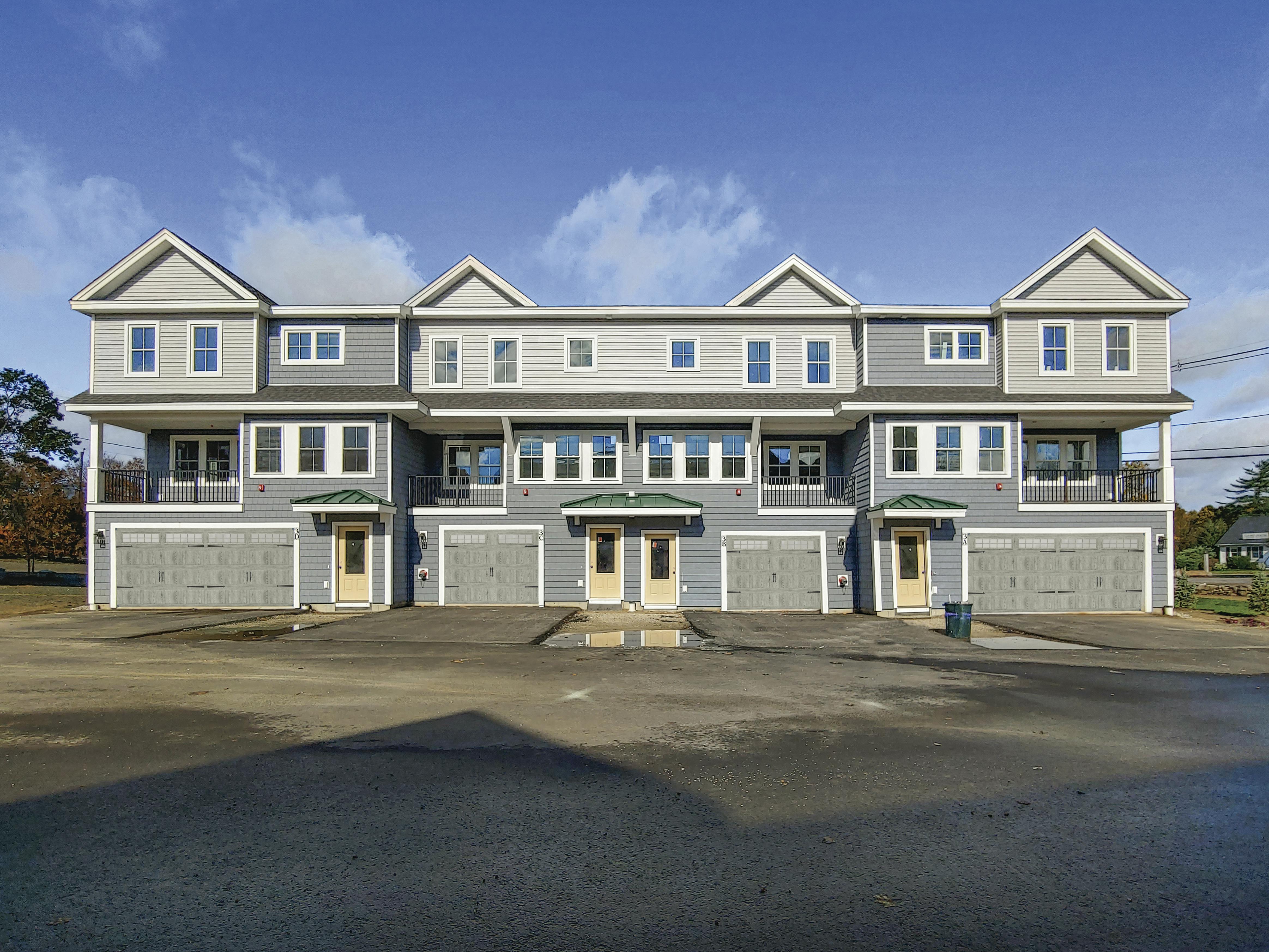 Front of a building showing garage doors and decks